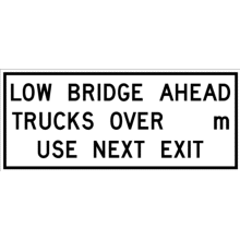 LOW BRIDGE AHEAD TRUCKS OVER XX m - USE NEXT EXIT